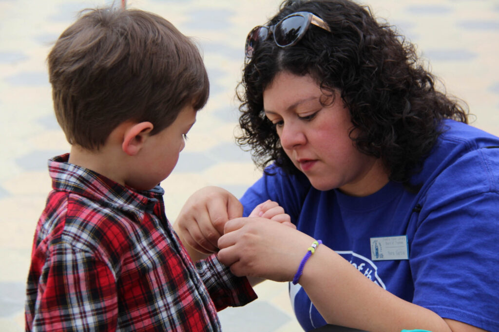 Nora helping a child at the Children's Festival.