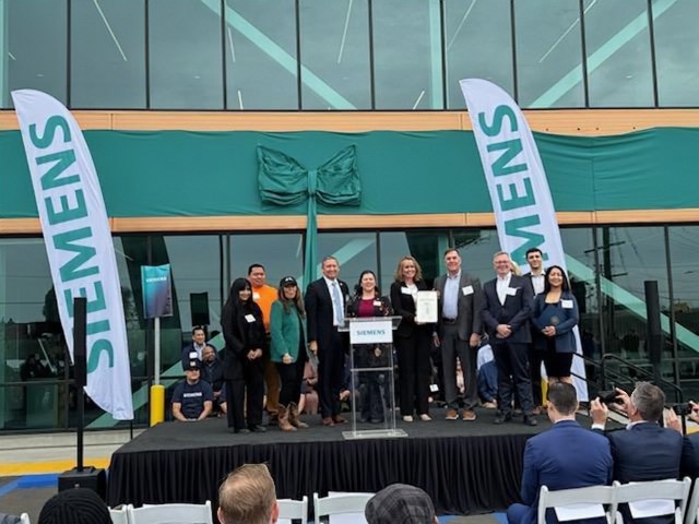 Nora speaking at the grand opening of the new Siemens factory in District 3.